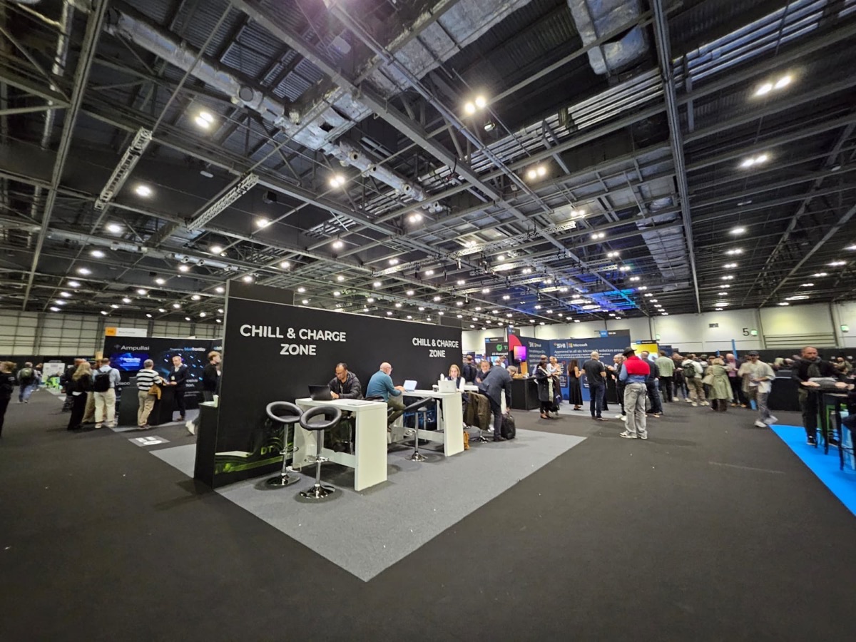 The DTX + UCX exhibition hall at ExCeL, with stands, crowds of visitors and a Chill and Charge Zone